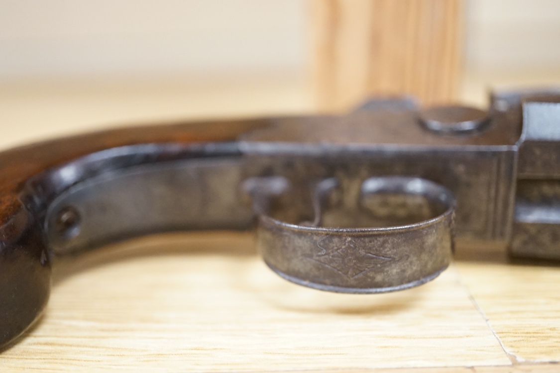 A double barrel flintlock, tap action pocket pistol by Collis of Oxford, with sliding top thumb safety, slab walnut grip, and tower private proof marks